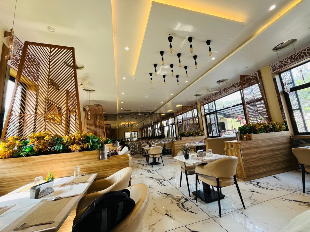 Restaurant seating and dining interior at Sai Samrat