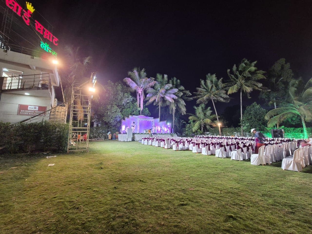 Sai Samrat wedding lawns lit at night with the stage and guest seating